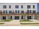 Modern townhome with white siding, black trim, garage, lawn and driveway at 1096 Glen Opal Dr, Decatur, GA 30032