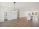 Open concept floor plan features modern lighting, wood floors and half bathroom at 1096 Glen Opal Dr, Decatur, GA 30032