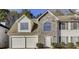 Charming two-story home with a two-car garage and beautiful stone accents at 2921 Russ Ln, Lithonia, GA 30058