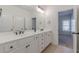 Neutral Primary bathroom featuring double sinks, vanity and an adjoining doorway at 3529 S Sherwood Se Rd, Smyrna, GA 30082