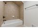 Bathroom featuring a tiled shower and tub combination with black fixtures at 3529 S Sherwood Se Rd, Smyrna, GA 30082