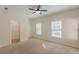 Bedroom featuring neutral carpet, paint, fan, windows and a walk in closet at 3529 S Sherwood Se Rd, Smyrna, GA 30082