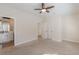 Bedroom featuring an open bathroom and closet doors, fan, and light neutral carpet at 3529 S Sherwood Se Rd, Smyrna, GA 30082
