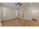 Spacious bedroom with hardwood floors, ceiling fan, and two windows with curtains and shutters at 3529 S Sherwood Se Rd, Smyrna, GA 30082