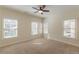 Bright, neutral bedroom featuring large windows, plush carpeting, and ample natural light at 3529 S Sherwood Se Rd, Smyrna, GA 30082