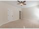Neutral bedroom featuring a ceiling fan, plush carpeting, and a white door at 3529 S Sherwood Se Rd, Smyrna, GA 30082