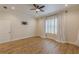 This bedroom features hardwood floors, ceiling fan, shuttered window and neutral walls at 3529 S Sherwood Se Rd, Smyrna, GA 30082