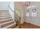 Bright foyer featuring hardwood floors, staircase, and elegant white double doors at 3529 S Sherwood Se Rd, Smyrna, GA 30082