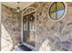 Elegant front entrance with stone detailing, round accent window, and festive holiday wreaths at 3529 S Sherwood Se Rd, Smyrna, GA 30082