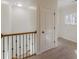 Upstairs hallway with carpet flooring, white walls and a window at 3529 S Sherwood Se Rd, Smyrna, GA 30082