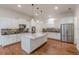 Elegant kitchen featuring white cabinets, stainless steel appliances, and a marble-topped island at 3529 S Sherwood Se Rd, Smyrna, GA 30082