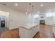Open layout showcasing a marble kitchen island and transitions into a living room with a fireplace at 3529 S Sherwood Se Rd, Smyrna, GA 30082
