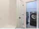The laundry room has modern black washer and dryer sets with gray tile flooring at 3529 S Sherwood Se Rd, Smyrna, GA 30082