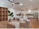 Open-concept living area with hardwood floors, a ceiling fan, and seamless flow into the modern kitchen at 3529 S Sherwood Se Rd, Smyrna, GA 30082