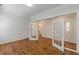 Open living area with hardwood floors, and glass paneled doors leading to foyer at 3529 S Sherwood Se Rd, Smyrna, GA 30082