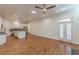 Open-plan living area next to kitchen, featuring hardwood floors and natural lighting at 3529 S Sherwood Se Rd, Smyrna, GA 30082