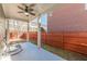 This is a cozy covered patio with ceiling fan and overlooks fenced backyard at 3529 S Sherwood Se Rd, Smyrna, GA 30082