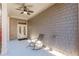 The covered patio has a ceiling fan, french doors, and a rocking chair at 3529 S Sherwood Se Rd, Smyrna, GA 30082