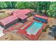 Aerial view of the home with a red roof, pool and surrounding landscape at 616 Rich Davis Rd, Hiram, GA 30141