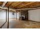 Unfinished basement with exposed wood ceiling, and painted brick fireplace at 616 Rich Davis Rd, Hiram, GA 30141