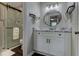 Updated bathroom features a modern vanity with marble countertop and a stylish round mirror at 616 Rich Davis Rd, Hiram, GA 30141