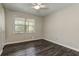 Well-lit bedroom featuring dark wood floors and a bright window view at 616 Rich Davis Rd, Hiram, GA 30141