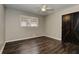 Bedroom featuring dark wood floors, a ceiling fan, and sliding barn doors to closet at 616 Rich Davis Rd, Hiram, GA 30141