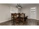 Dining area featuring a rustic table and chairs, wood floors, and a window providing natural light at 616 Rich Davis Rd, Hiram, GA 30141