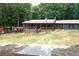 Ranch-style home with a red roof, covered porch, and landscaped yard at 616 Rich Davis Rd, Hiram, GA 30141