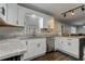 Well-lit kitchen showcases countertops, ample cabinetry, and updated appliances, perfect for cooking enthusiasts at 616 Rich Davis Rd, Hiram, GA 30141