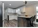 Kitchen with white cabinets, stainless steel appliances, and a breakfast bar, perfect for casual dining at 616 Rich Davis Rd, Hiram, GA 30141