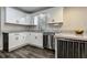 Updated kitchen featuring white cabinetry, stone countertops, and a stainless steel dishwasher for convenience at 616 Rich Davis Rd, Hiram, GA 30141