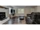 Comfortable living room featuring wood floors, a fireplace, and a large window offering natural light at 616 Rich Davis Rd, Hiram, GA 30141