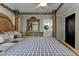 Main bedroom offers a four-poster bed, wood floors, natural light, and view into the en-suite bathroom at 616 Rich Davis Rd, Hiram, GA 30141