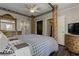 Main bedroom boasts a four-poster bed, wood floors, natural light, and en-suite bathroom at 616 Rich Davis Rd, Hiram, GA 30141