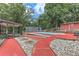 Backyard pool featuring a red deck, surrounded by mature trees, with outbuildings in a secluded setting at 616 Rich Davis Rd, Hiram, GA 30141