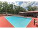 In-ground pool with a red deck, complemented by backyard views and mature trees for a serene retreat at 616 Rich Davis Rd, Hiram, GA 30141