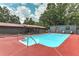 In-ground pool with a red deck, complemented by backyard views and mature trees for a serene retreat at 616 Rich Davis Rd, Hiram, GA 30141