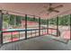 Screened porch with ceiling fan, offering a relaxing view of the backyard, pool and surrounding landscape at 616 Rich Davis Rd, Hiram, GA 30141