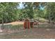 Backyard scene featuring outbuildings, offering potential for various outdoor activities and hobbies at 616 Rich Davis Rd, Hiram, GA 30141