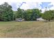 Spacious grassy yard featuring a camper, outbuilding, and house at 616 Rich Davis Rd, Hiram, GA 30141
