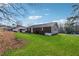 Lush grassy backyard with mature trees offering serene privacy at 145 Pinehurst Dr, Stockbridge, GA 30281