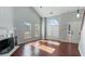 Sun-filled living room with hardwood floors, a fireplace, and a large arched window with pleated shades at 4146 Mcever Park Dr, Acworth, GA 30101