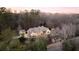 Gorgeous custom home on wooded lot showcases beautiful stonework, professional landscaping, and elegant design at 4755 Columns Se Dr, Marietta, GA 30067
