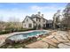 Stunning backyard with a custom pool, stone accents, and elegant landscaping at 4755 Columns Se Dr, Marietta, GA 30067