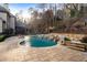 Beautiful backyard pool area with stone waterfall, patio, and lush landscaping at 4755 Columns Se Dr, Marietta, GA 30067