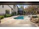 View of the backyard pool with rock waterfall feature and lovely patio area at 4755 Columns Se Dr, Marietta, GA 30067