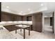Basement kitchenette area with granite countertops, custom wood cabinetry, and a center island at 4755 Columns Se Dr, Marietta, GA 30067