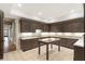 Basement kitchenette area with granite countertops, custom wood cabinetry, and a center island at 4755 Columns Se Dr, Marietta, GA 30067