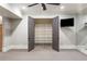 Basement walk-in closet with open shelving for ample storage; flat screen tv installed on wall at 4755 Columns Se Dr, Marietta, GA 30067